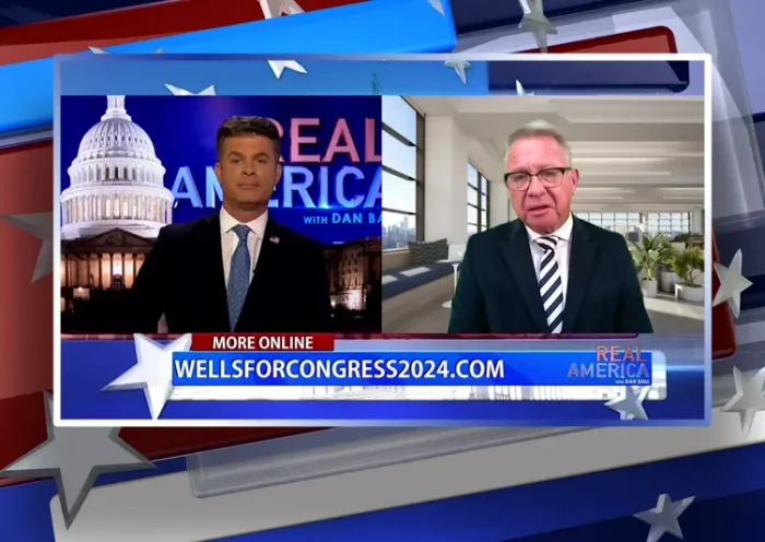 Video still from Real America on One America News Network showing a split screen of the host on the left side, and on the right side is the guest, Bill Wells.