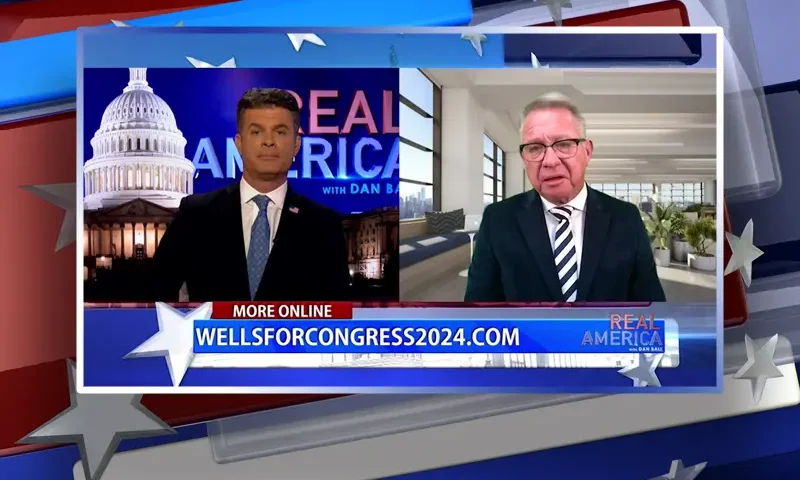 Video still from Real America on One America News Network showing a split screen of the host on the left side, and on the right side is the guest, Bill Wells.
