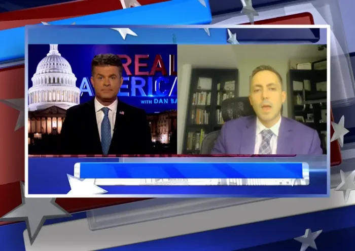Video still from Real America on One America News Network showing a split screen of the host on the left side, and on the right side is the guest, Dean McGee.