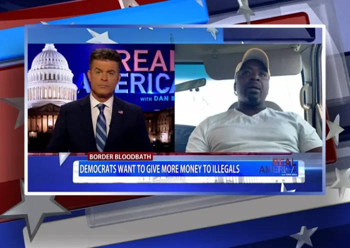Video still from Real America on One America News Network showing a split screen of the host on the left side, and on the right side is the guest, Mark "King" Carter.