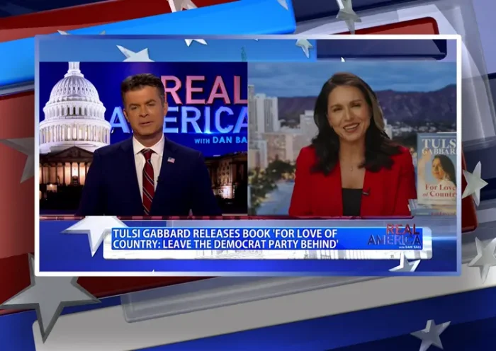 Video still from Real America on One America News Network showing a split screen of the host on the left side, and on the right side is the guest, Tulsi Gabbard.