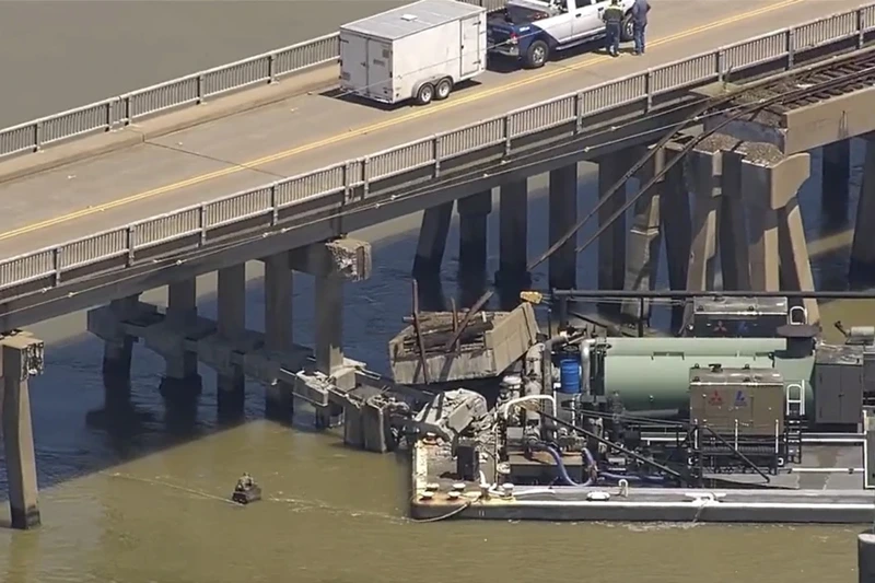 Oil spills into the surrounding waters after a barge hit a bridge in Galveston, Texas, on Wednesday, May 15, 2024. A bridge that leads to Pelican Island, located just north of Galveston, was hit by a barge around 9:30 a.m., said Ronnie Varela, with the Galveston's Office of Emergency Management.(KTRK via AP)