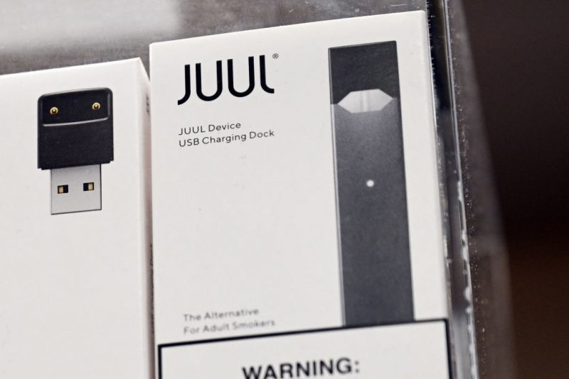 JUUL Labs Inc. vaping e-cigarette device and USB charging dock are displayed in a convenience store on June 23, 2022 in El Segundo, California. Vaping company Juul Labs said Thursday it would appeal a decision by the US Food and Drug Administration ordering all its products off the market, a move the agency said was based on safety concerns. (Photo by Patrick T. FALLON / AFP) (Photo by PATRICK T. FALLON/AFP via Getty Images)