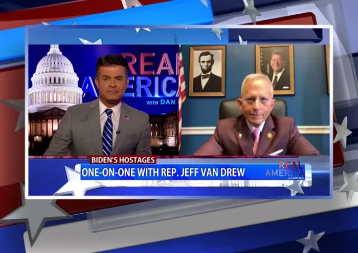 Video still from Real America on One America News Network showing a split screen of the host on the left side, and on the right side is the guest, Rep. Jeff Van Drew.