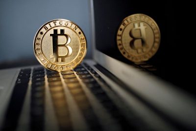 FILE PHOTO: A bitcoin is seen in an illustration picture taken at La Maison du Bitcoin in Paris, France, June 23, 2017. REUTERS/Benoit Tessier