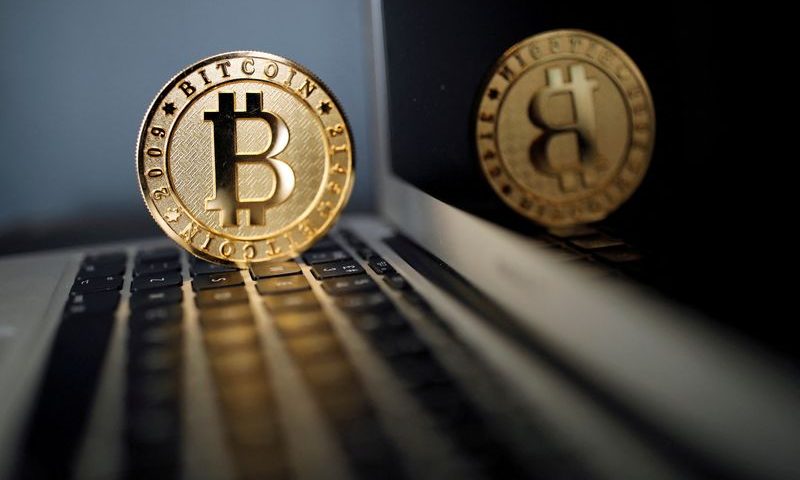 FILE PHOTO: A bitcoin is seen in an illustration picture taken at La Maison du Bitcoin in Paris, France, June 23, 2017. REUTERS/Benoit Tessier