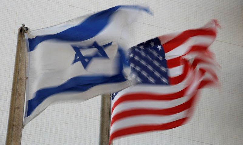 FILE PHOTO: The American and the Israeli national flags can be seen outside the U.S Embassy in Tel Aviv
